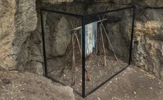 Each glass vitrine is exhibited on earthy slopes and in rocky caves