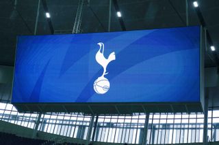 The Tottenham Hotspur badge on a big screen at the Tottenham Hotspur Stadium