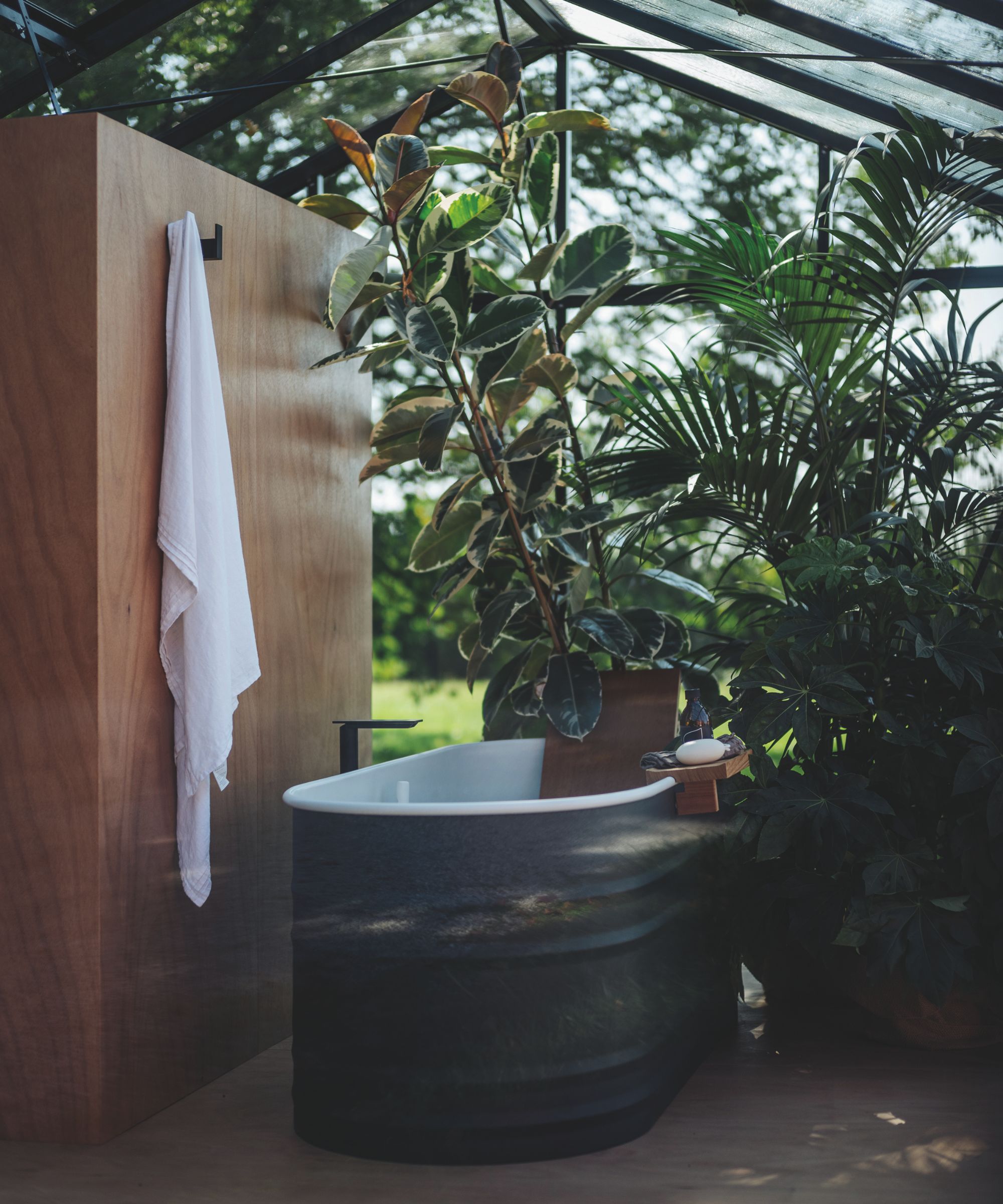 An outdoor bathroom located in a greenhouse
