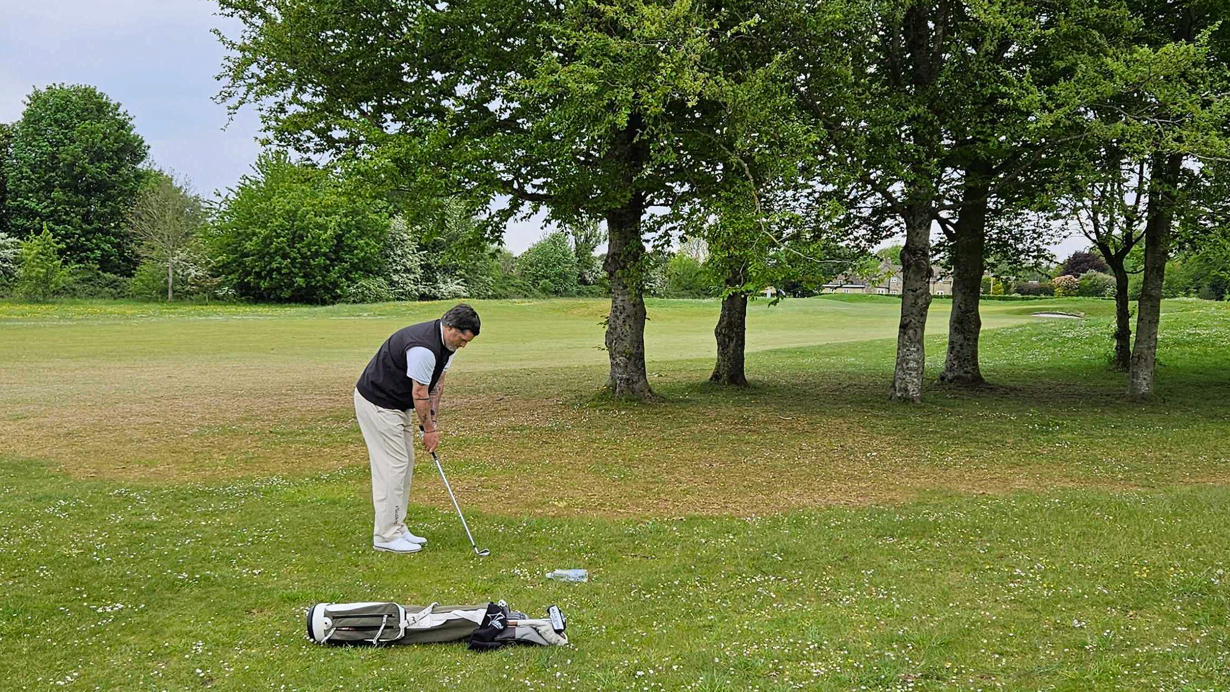 Joe Ferguson plays out from behind trees during a PGA event at Minchinhampton Golf Club