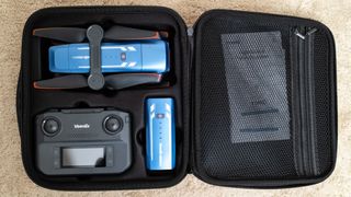 Veeniix V11PRO drone in a case with a controller and battery on a beige carpet