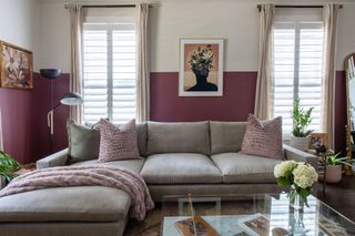 Living room with half-up mauve pink walls and light grey corner sofa