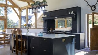 Blue shaker kitchen by Olive &amp; Barr in oak frame room