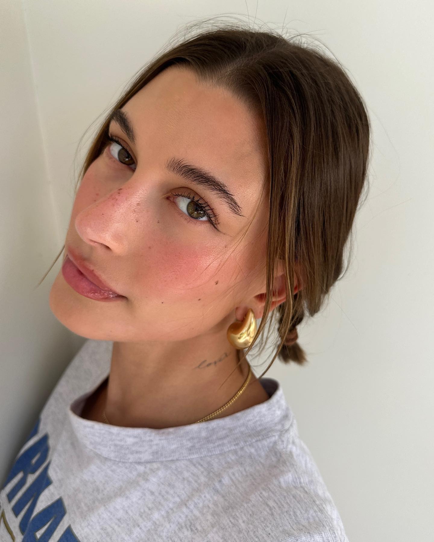 Hailey Bieber with her bob hairstyle styled into a plait