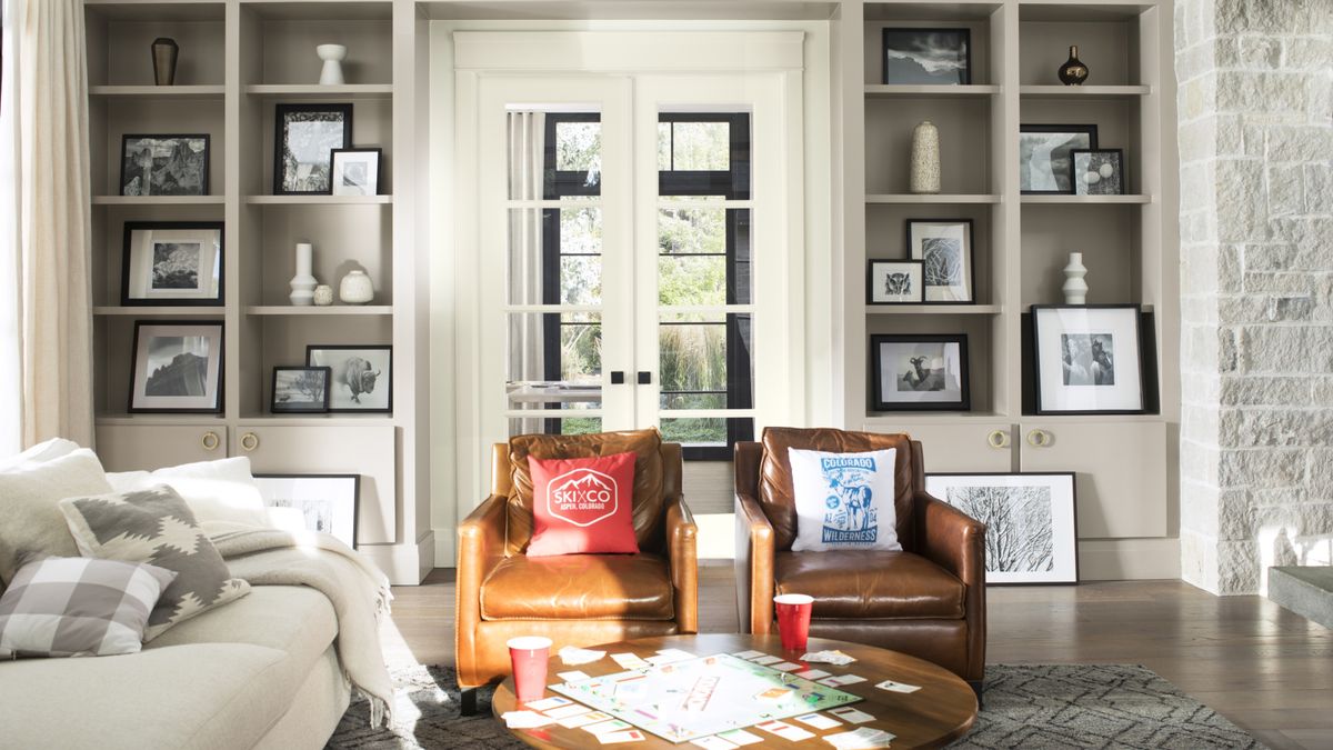 neutral living room scheme with leather armchairs and glass internal doors