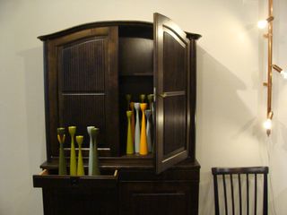 coloured candlesticks displayed in a classic brown sideboard