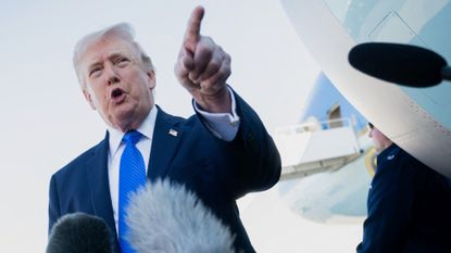 Donald Trump talks to reporters before boarding Air Force One in Florida on Monday