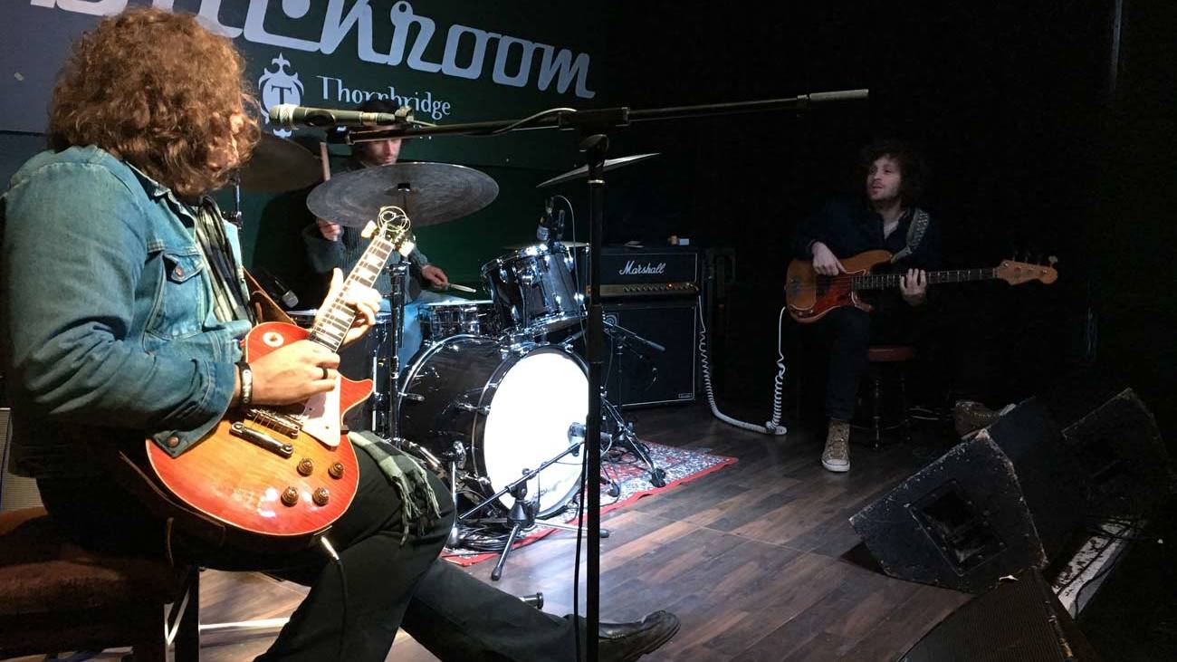 JD Simo performing from a stool in Sheffield on April 6