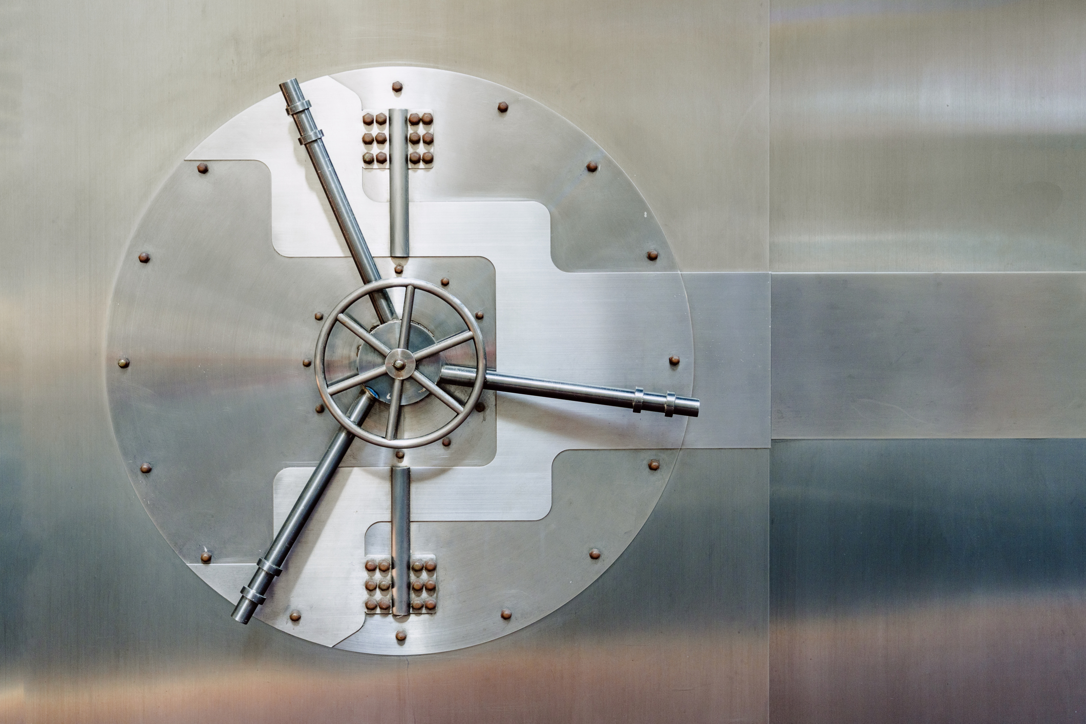 Round vault door with visible locking mechanism, symbolizing banking security and protection of valuables