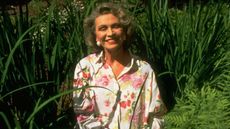Author Anne Rivers Siddons sitting in a garden