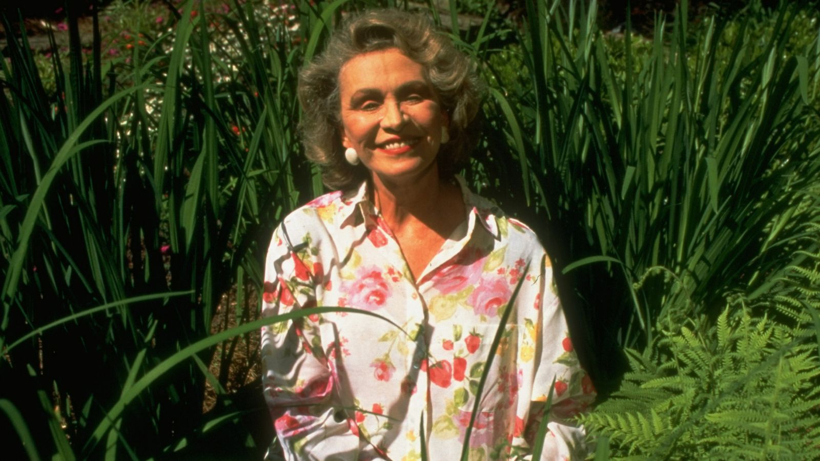 Author Anne Rivers Siddons sitting in a garden