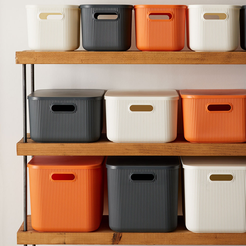 Wooden shelves with storage boxes and white walls