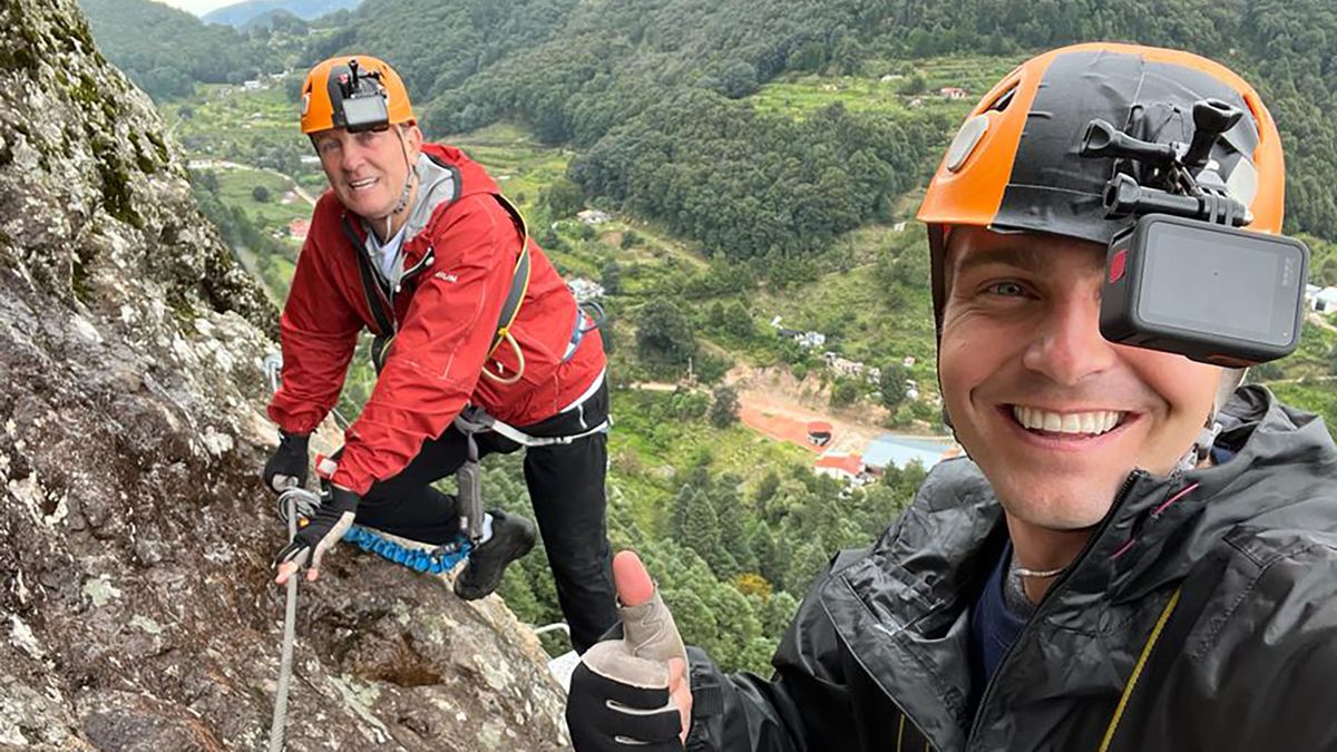 Bradley and Barney Walsh in climbing gear on the side of a mountain for Breaking Dad.