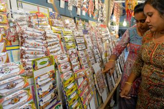 Indian women shop for 'rakhi' on the eve of the Hindu festival 'Raksha Bandhan' in Bangalore on August 28, 2015. The 'Raksha Bandhan' ritual is observed on the full moon in the Hindu month of
