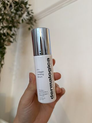 Mica Ricketts holding bottle of Dermalogica Pro-Collagen Banking Serum