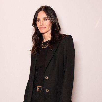 Courteney Cox in front of a step and repeat at Marie Claire's power play event