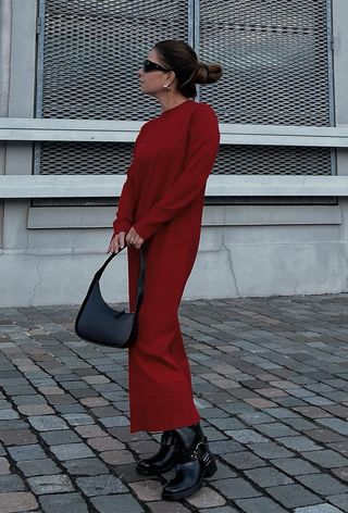 a photo of a woman wearing a red knit dress with black moto boots