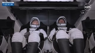 Two Crew-9 astronauts sit inside their SpaceX Dragon capsule awaiting launch.