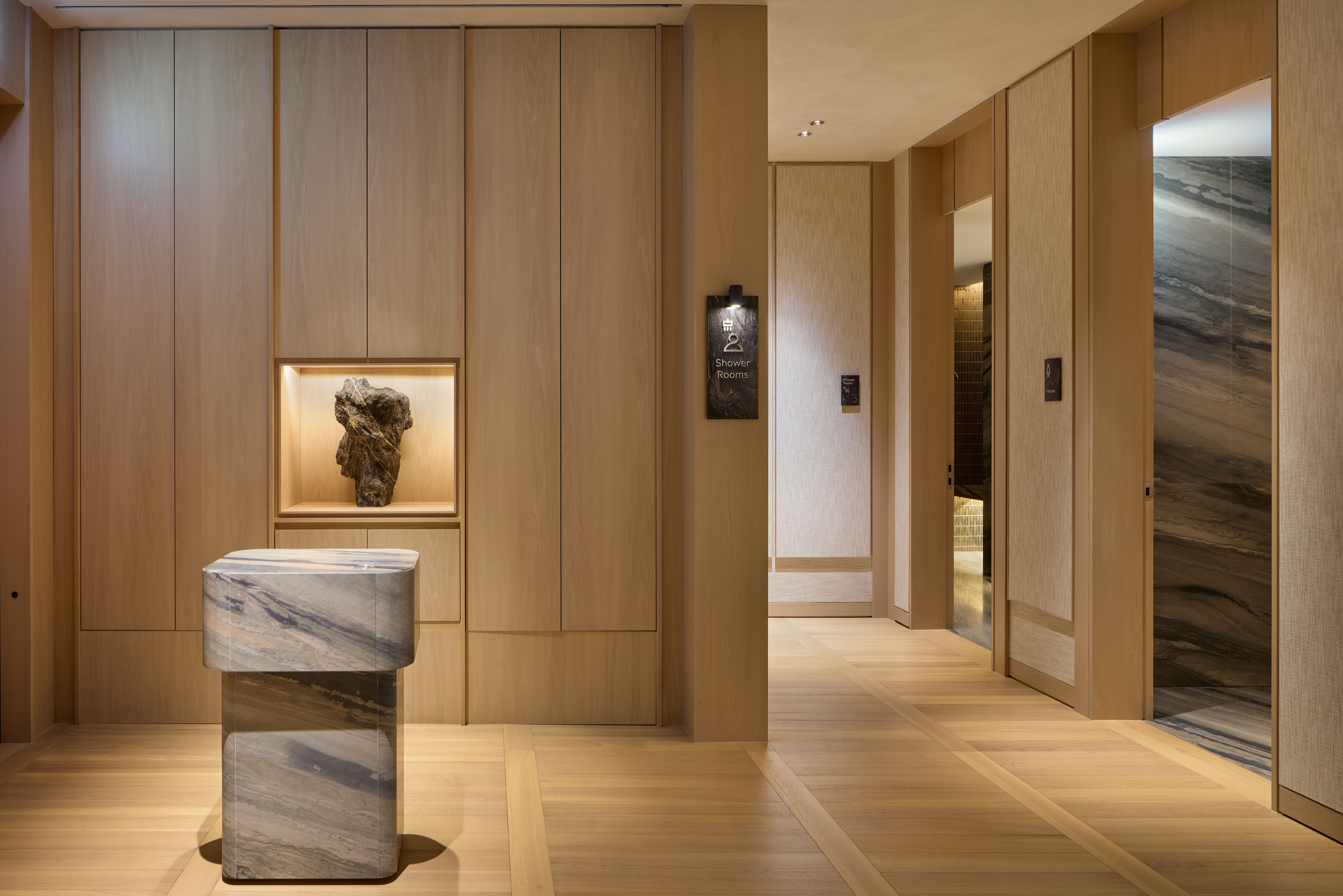 A spacious lounge interior at Incheon International Airport combines contemporary furnishings, natural textures and distinct areas for dining, work and relaxation