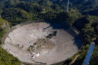 This aerial view shows the damage at the Arecibo Observatory after one of the main cables holding the receiver broke in Arecibo, Puerto Rico, on December 1, 2020.