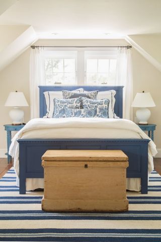 bedroom with white bedding with blue accents