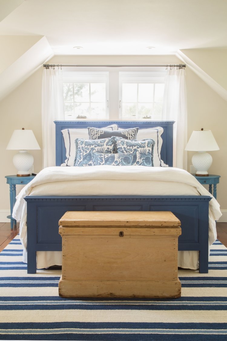 bedroom with white bedding with blue accents