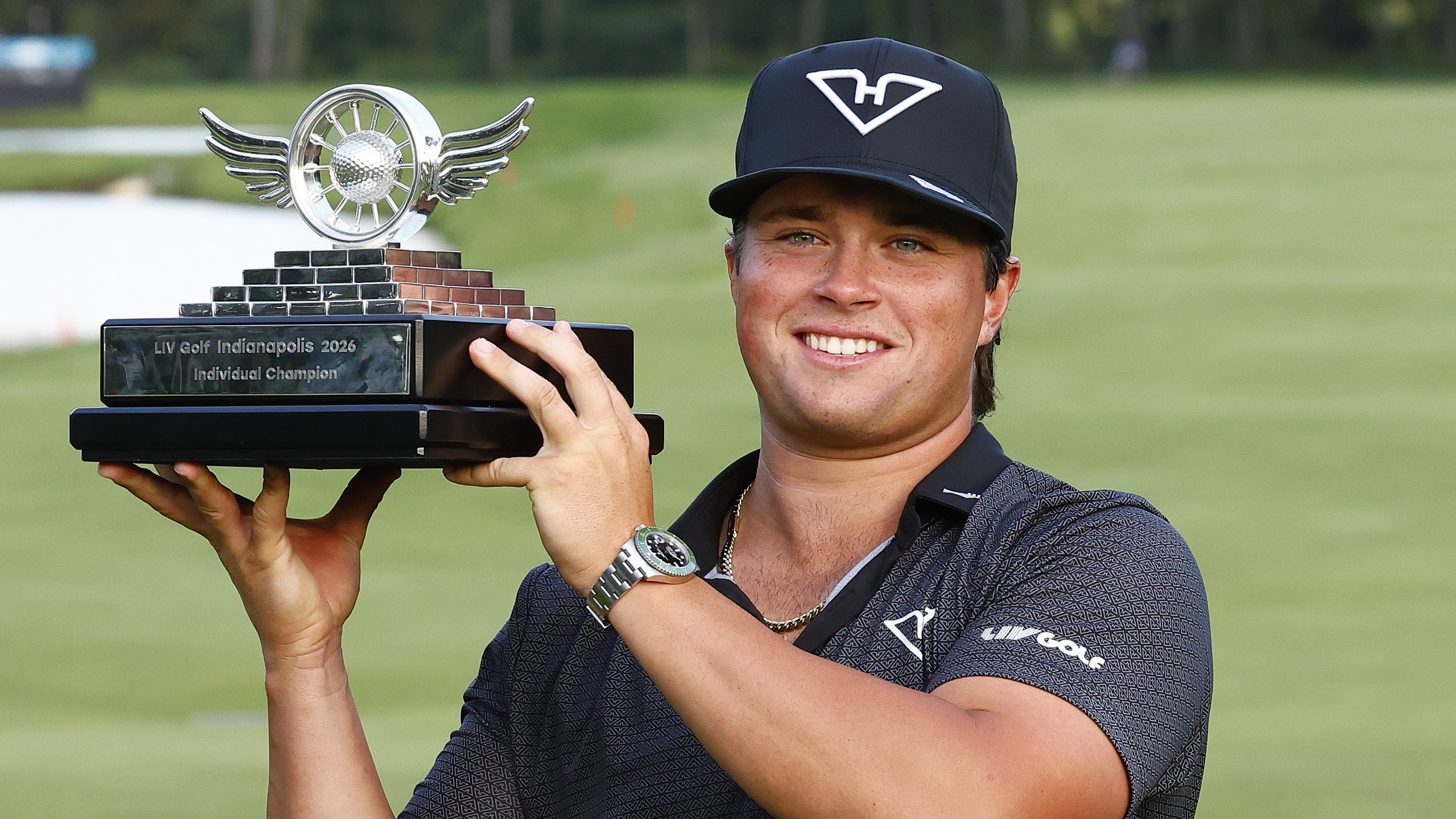 Michael La Sasso lifts the LIV Golf Indianapolis trophy after winning the final event of the 2026 season