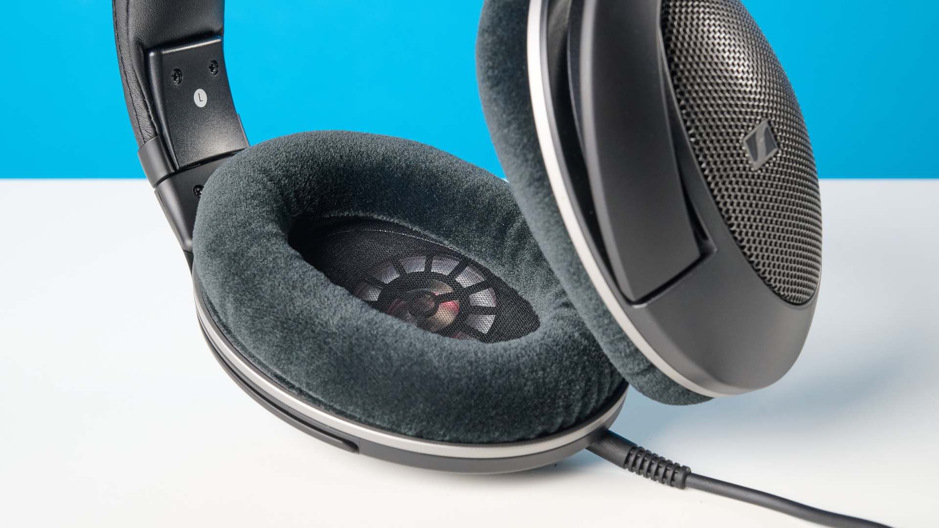 The Sennheiser HD 550 headphones on a stone surface with a blue background