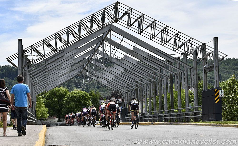 The riders pass over a bridge