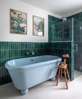 Bathroom with a blue bath and green tiles