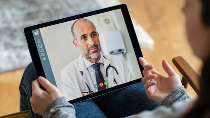 A doctor on a video call © Getty Images/iStockphoto
