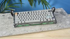 A gray GravaStar Mercury K1 Pro mechanical keyboard, with spider legs