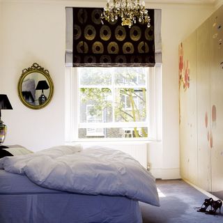 bedroom with white walls and chandelier