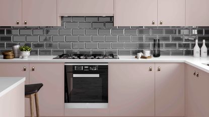 kitchen with pink coloured and black tiles on wall