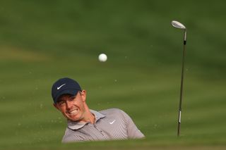 Rory McIlroy hits a wedge shot and watches its flight