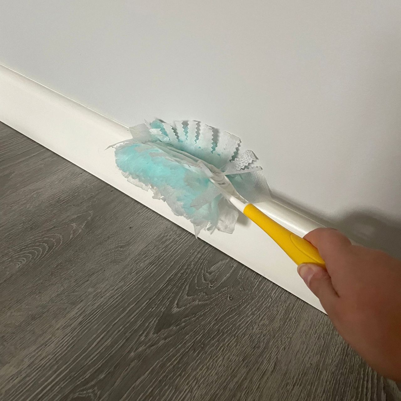 Using Flash Dust Magnet duster to wipe down white skirting boards