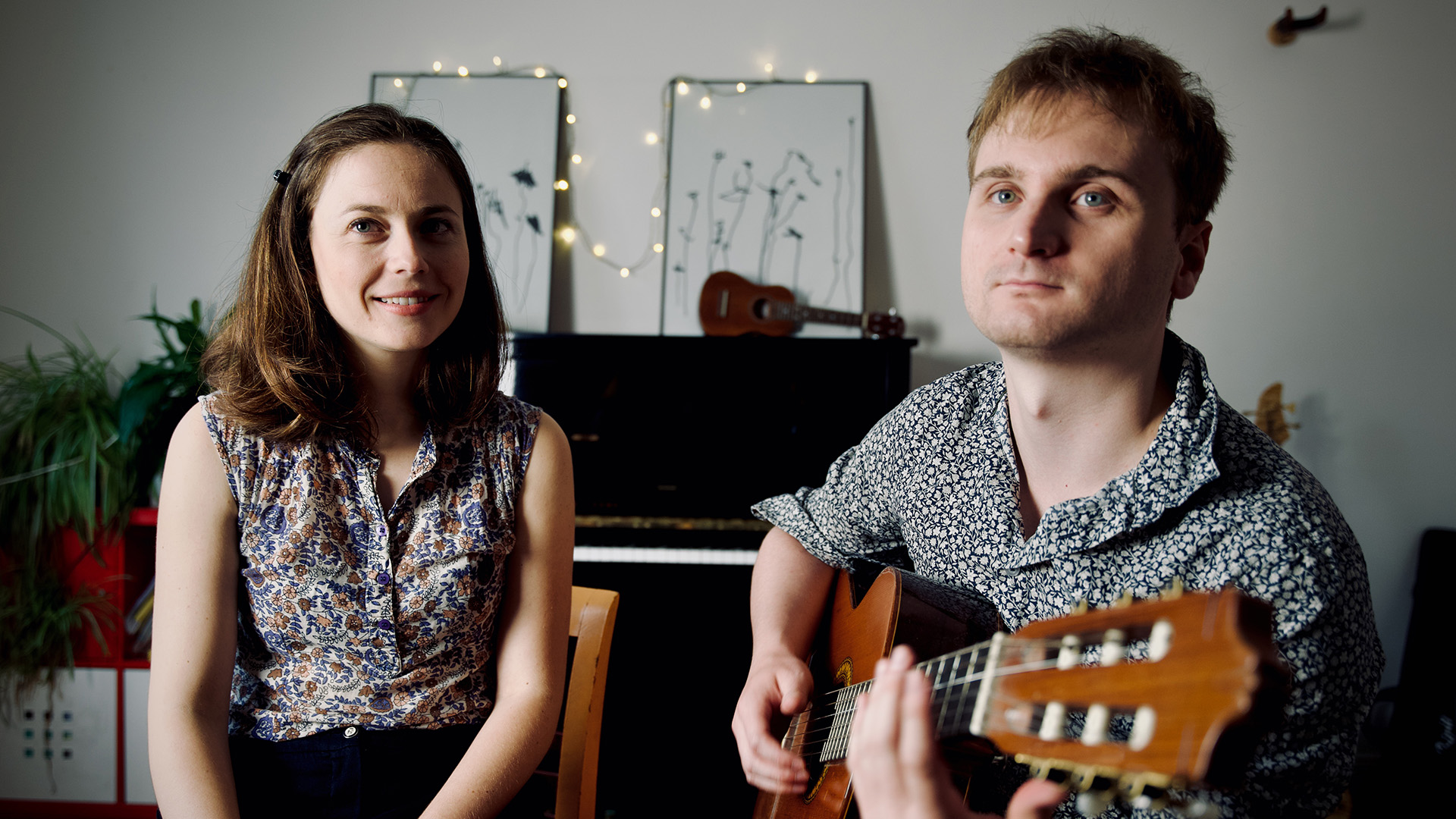 Composer Lorien Testard holds a guitar with vocalist Alice Duport-Percier sits next to him, the two having worked on Clair Obscur: Expedition 33's music