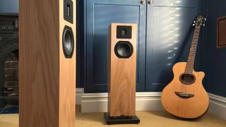 Neat Acoustics Mystique Classic speakers in living room next to guitar