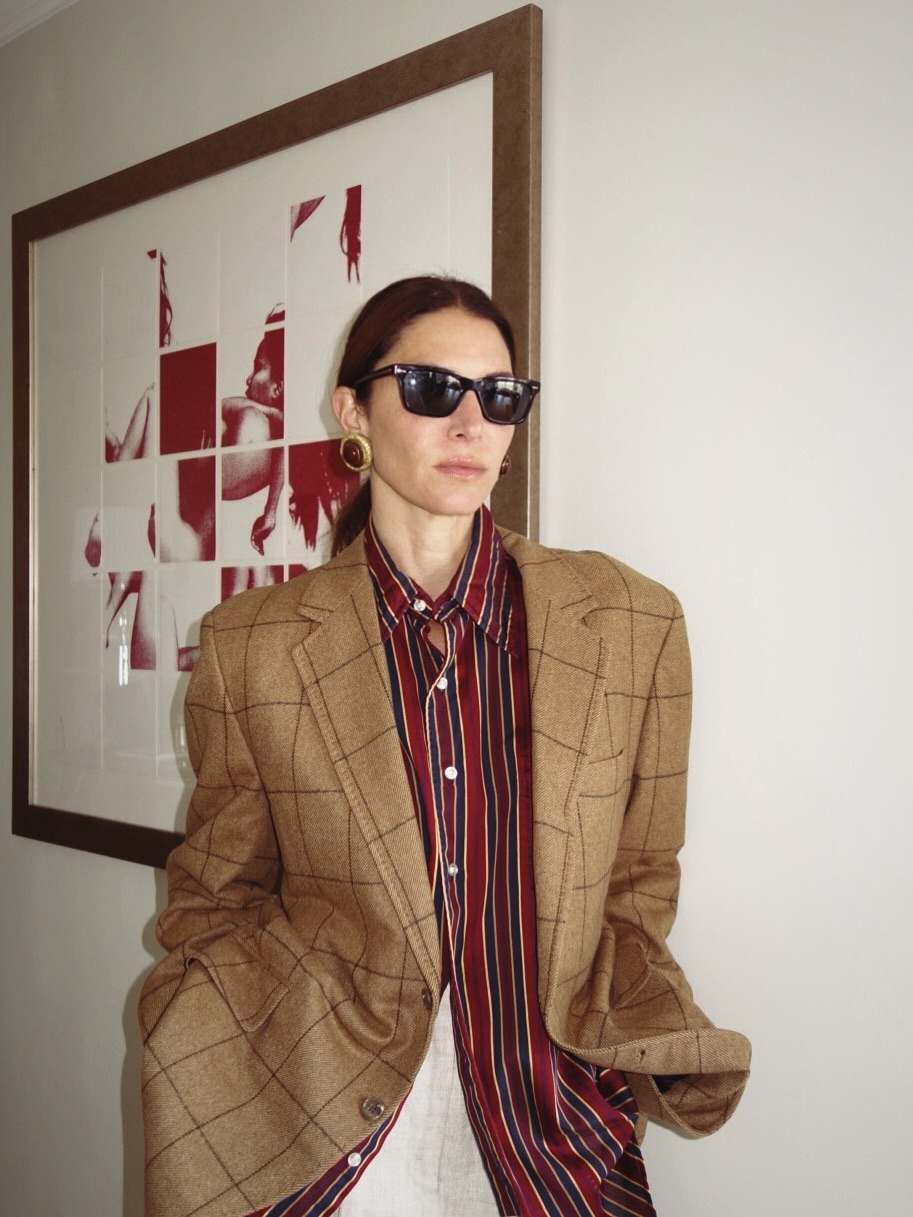 Woman wearing plaid jacket trend fall 2025.