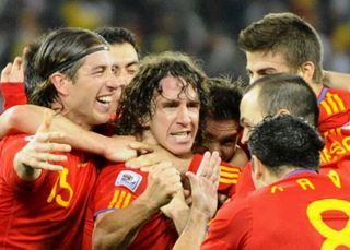 Carles Puyol celebrates with his Spain team-mates after scoring against Germany in the 2010 World Cup.