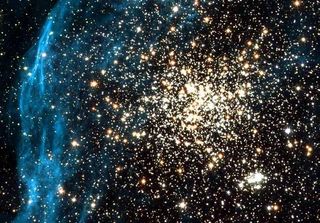 A globular cluster (yellow) shines in the Large Magellanic cloud, one of the Milky Way's smaller satellite galaxies.