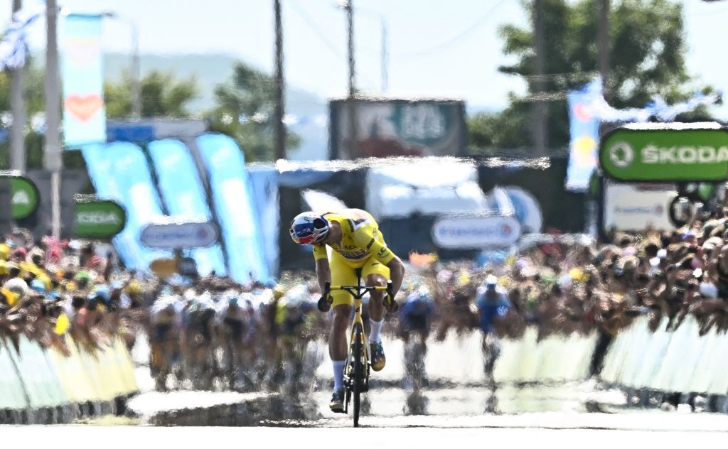 TOPSHOT JumboVisma teams Belgian rider Wout Van Aert looks back at the pursuing pack of riders as he cycles the final meters to the finish line to win the 4th stage of the 109th edition of the Tour de France cycling race 1715 km between Dunkirk and Calais in northern France on July 5 2022 Photo by AnneChristine POUJOULAT AFP Photo by ANNECHRISTINE POUJOULATAFP via Getty Images