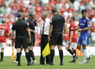 Sir Alex Ferguson speaks to referee Chris Foy at full time in the 2009 Community Shield clash between Manchester United and Chelsea in August 2009.