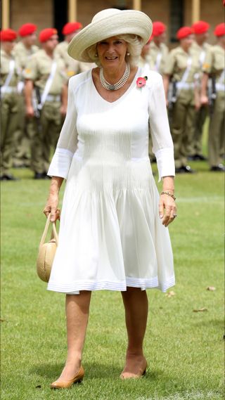 Queen Camilla in a classic white dress