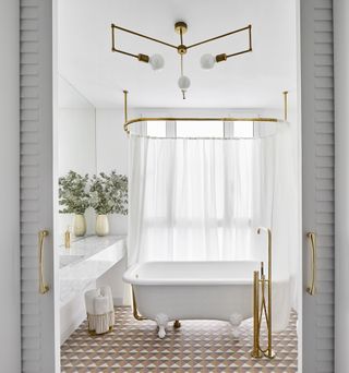 bathroom with elegant white curtain around the bath