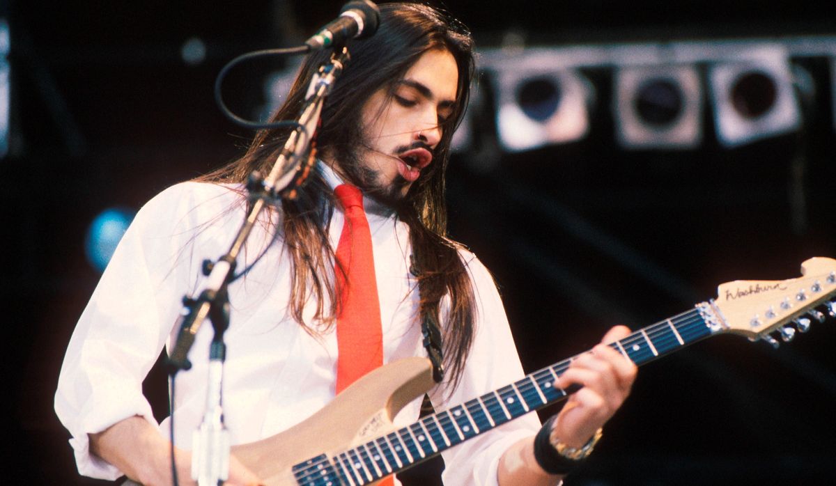 Nuno Bettencourt performs with Extreme at Wembley Stadium in London during the The Freddie Mercury Tribute Concert for AIDS Awareness on April 20, 1992