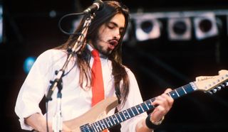 Nuno Bettencourt performs with Extreme at Wembley Stadium in London during the The Freddie Mercury Tribute Concert for AIDS Awareness on April 20, 1992