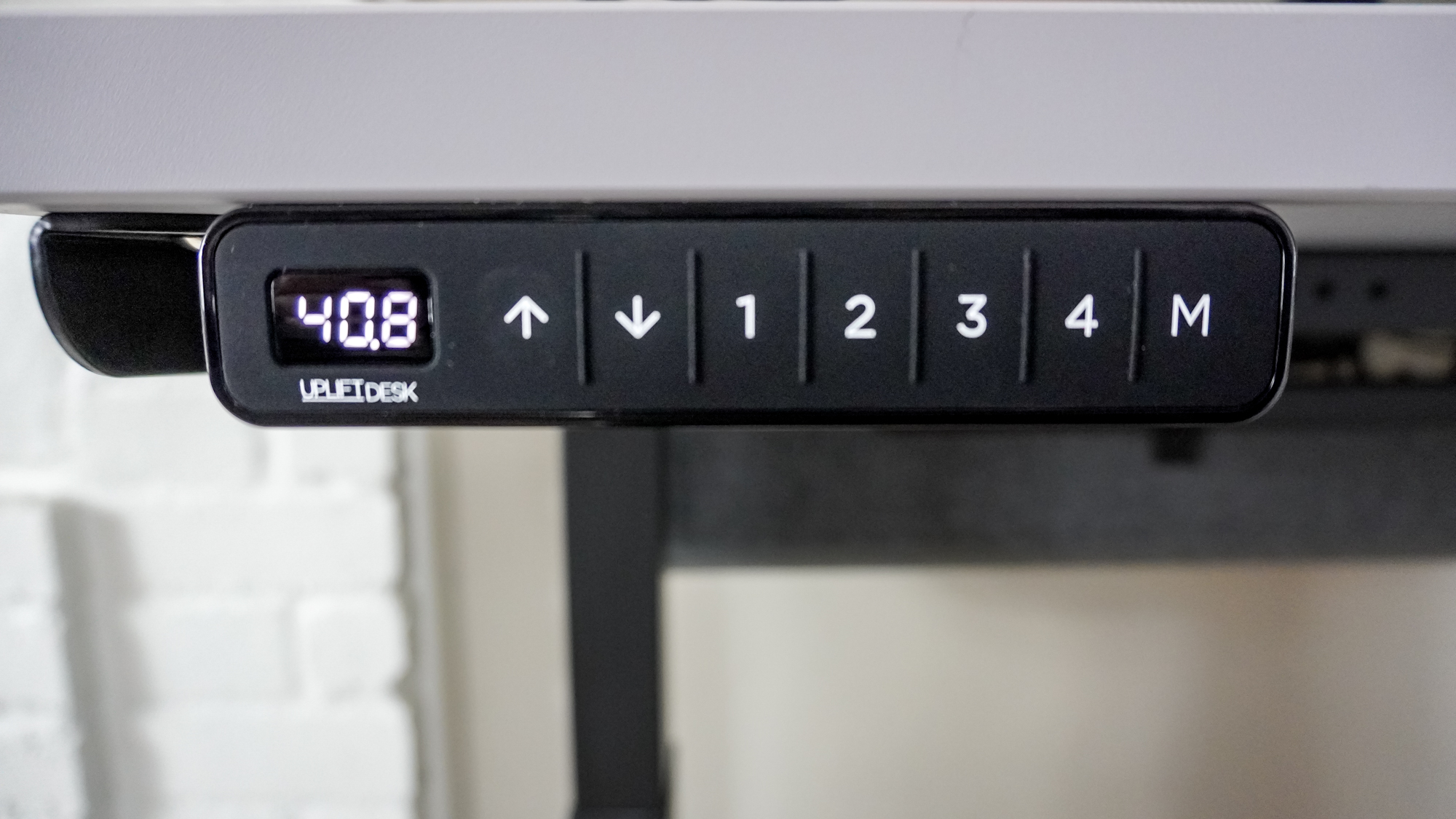 A closeup shot of the Uplift's Advanced Comfort Flush Keypad on the Uplift V3 standing desk
