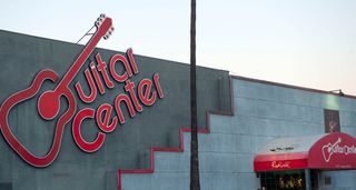 A landscape shot of the iconic Guitar Center logo and shop entrance to its Sunset Boulevard store.