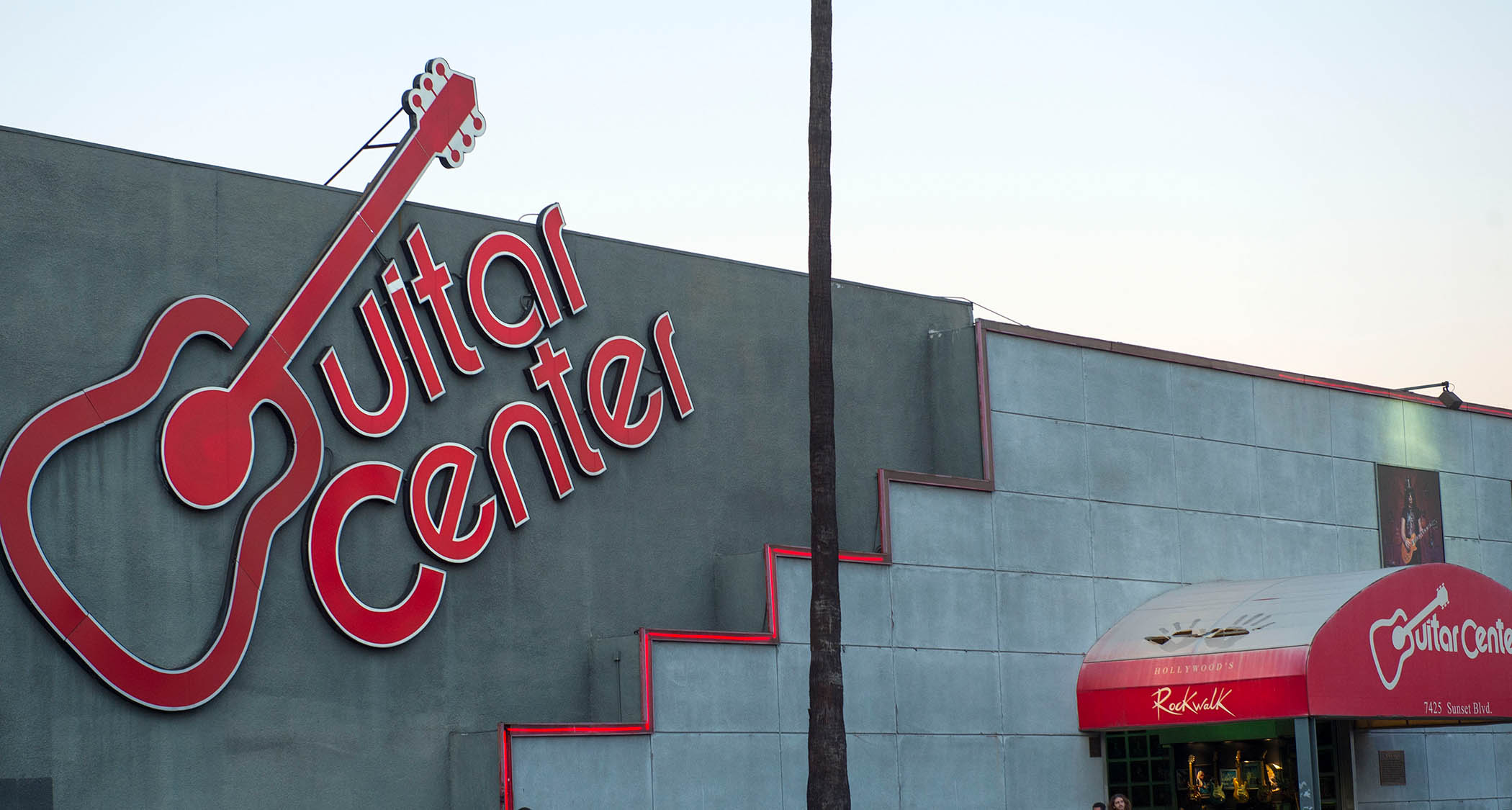 A landscape shot of the iconic Guitar Center logo and shop entrance to its Sunset Boulevard store.